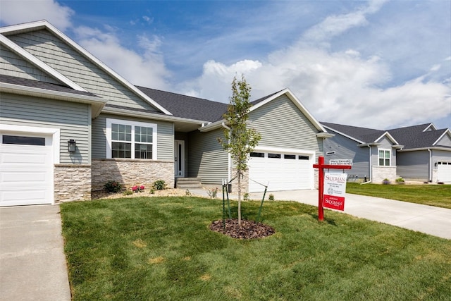 1932 Bowstring Dr, Marion, IA 52302 - craftsman-style home featuring an attached garage, concrete driveway, a front lawn, and stone siding