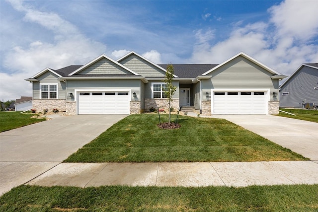 1932 Bowstring Dr, Marion, IA 52302 - view of front facade featuring concrete driveway, stone siding, and an attached garage
