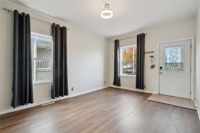 entrance foyer featuring wood-type flooring and crown molding