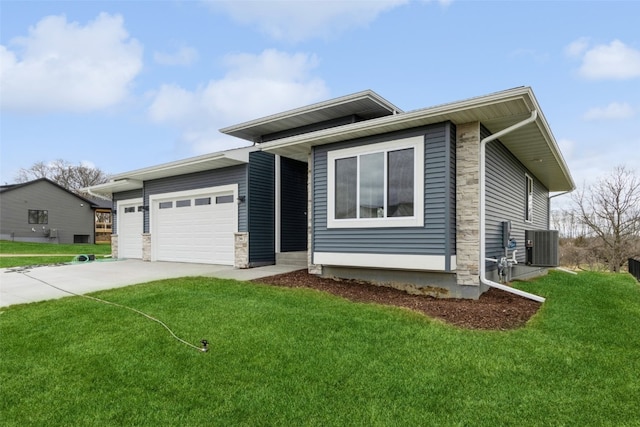 view of front facade with a front lawn, a garage, and central AC unit