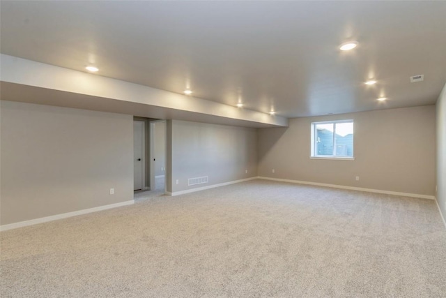 basement featuring light colored carpet