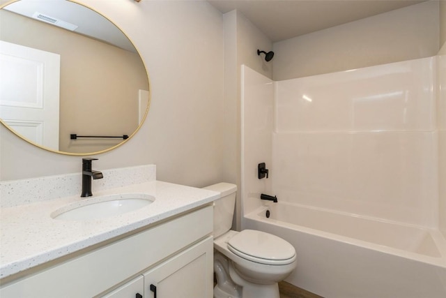 full bathroom featuring vanity, bathtub / shower combination, and toilet