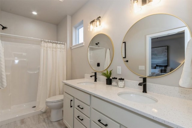 bathroom featuring vanity, curtained shower, and toilet