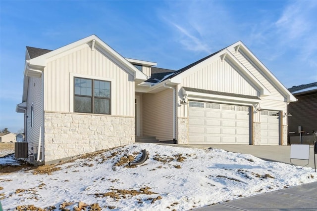 view of front of property with central AC and a garage