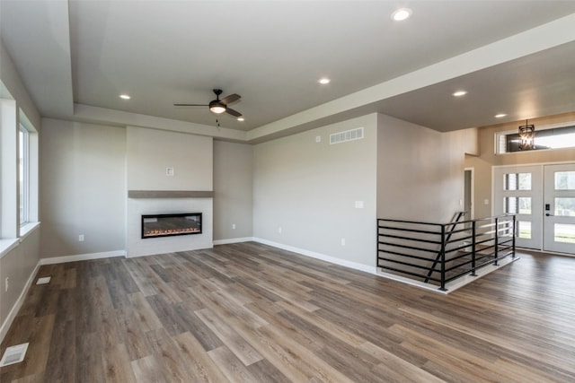 unfurnished living room featuring hardwood / wood-style floors and ceiling fan