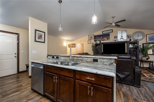 kitchen with lofted ceiling, dark wood-type flooring, sink, an island with sink, and decorative light fixtures