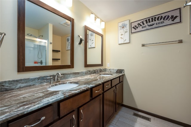 bathroom with vanity and a shower