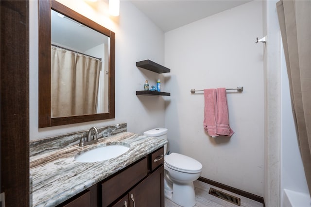 bathroom featuring toilet, a shower with curtain, vanity, and tile patterned floors