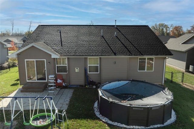 rear view of property featuring a patio and a yard