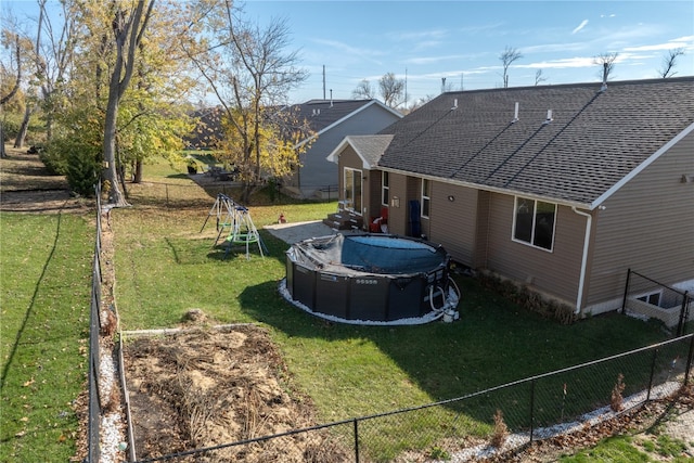 view of yard featuring a playground and a covered pool