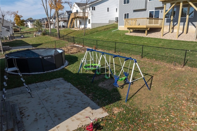 view of jungle gym featuring a lawn and a pool side deck