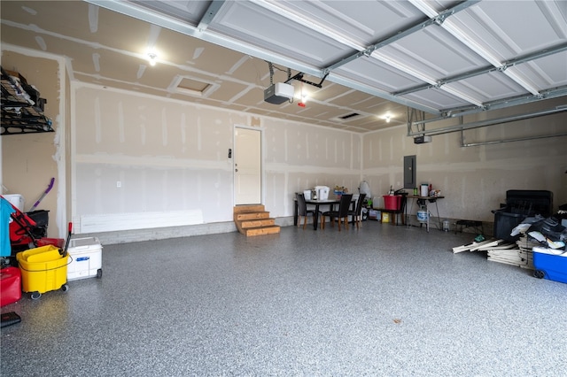 garage featuring electric panel and a garage door opener