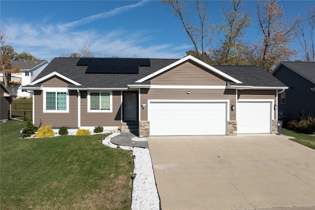 single story home with a front lawn, a garage, and solar panels