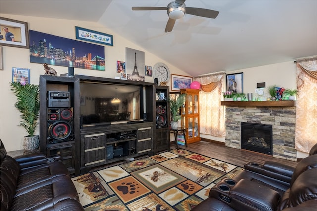 living room featuring a stone fireplace, lofted ceiling, ceiling fan, and wood-type flooring