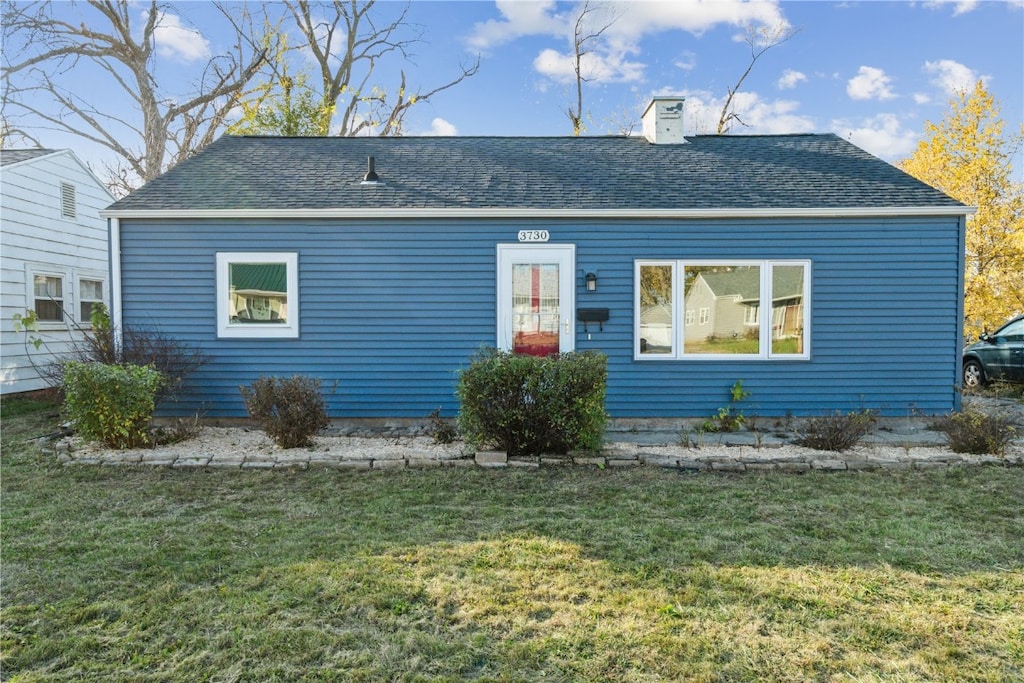 rear view of house with a yard