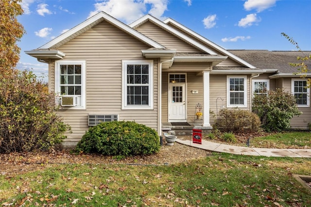 view of front of house with cooling unit and a front yard