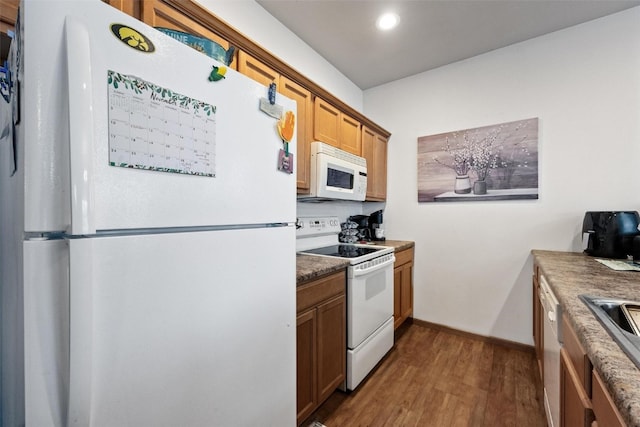 kitchen with dark wood-type flooring and white appliances