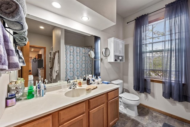 bathroom featuring toilet and vanity