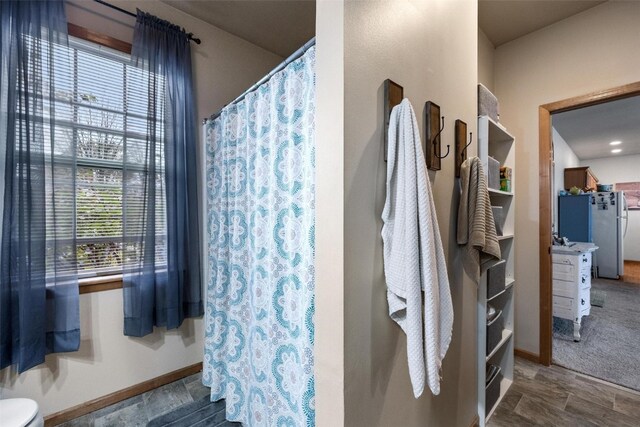 bathroom featuring plenty of natural light and toilet