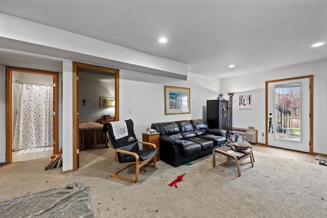 living room with a wall mounted AC and light hardwood / wood-style flooring