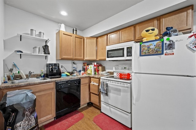 kitchen with light hardwood / wood-style floors, sink, and white appliances