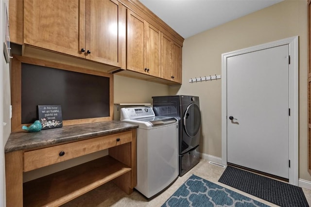 washroom featuring cabinets and independent washer and dryer