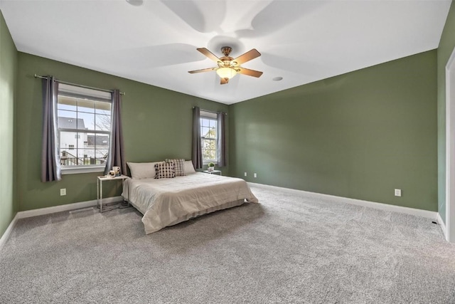 bedroom featuring multiple windows, carpet floors, and ceiling fan