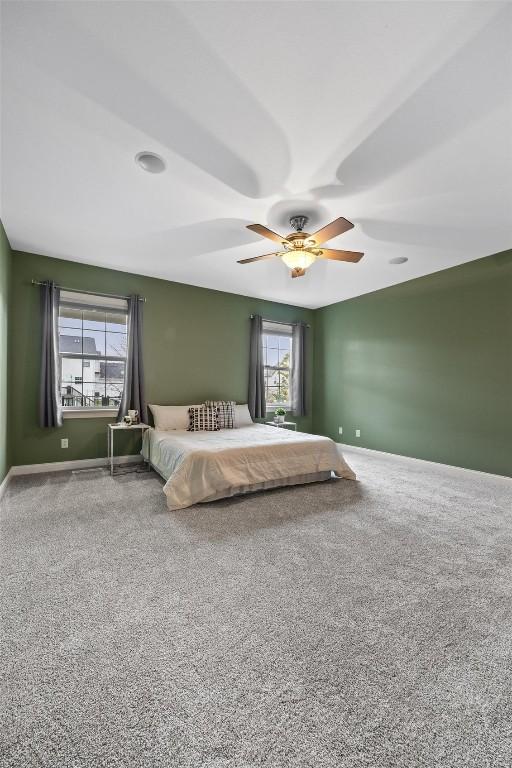 unfurnished bedroom with ceiling fan and carpet flooring