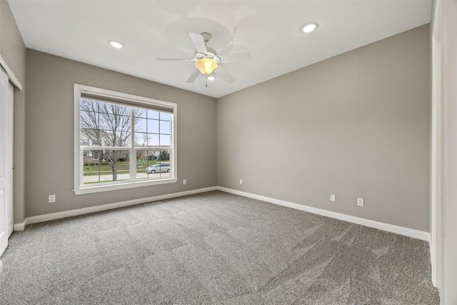 unfurnished room featuring ceiling fan and carpet