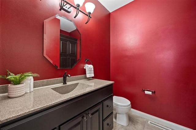 bathroom with tile patterned floors, vanity, and toilet