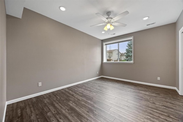 unfurnished room featuring ceiling fan and dark hardwood / wood-style floors