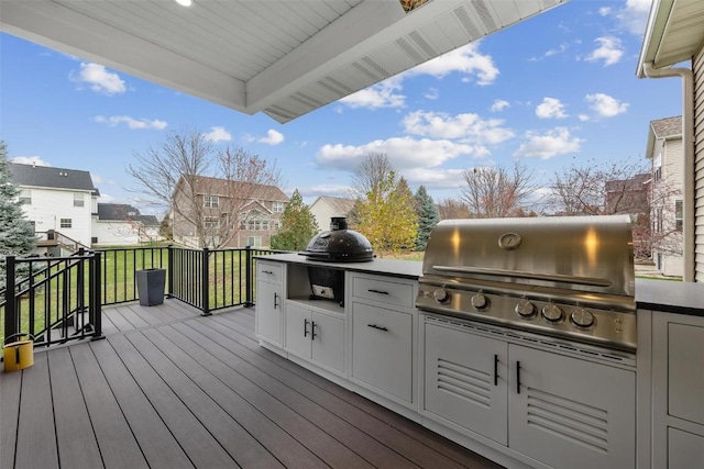 wooden deck featuring a lawn and area for grilling