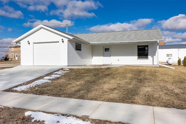 ranch-style house featuring a garage and a front lawn