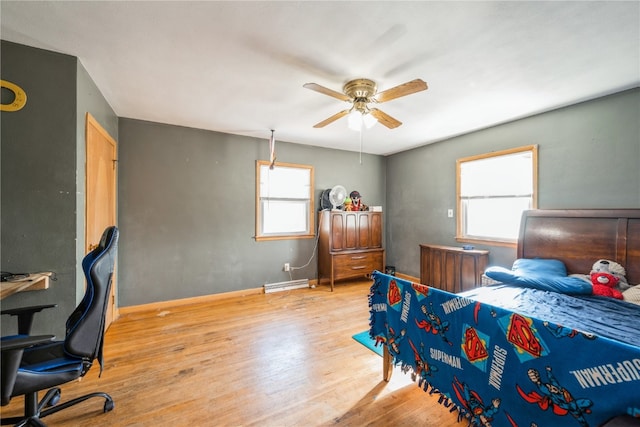 bedroom with ceiling fan, light hardwood / wood-style floors, and multiple windows