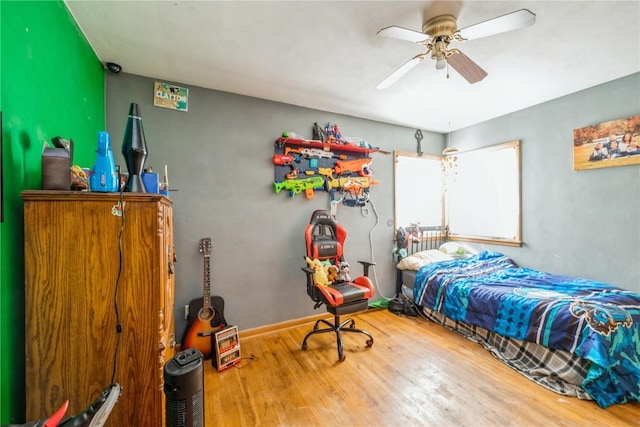 bedroom with ceiling fan and wood-type flooring