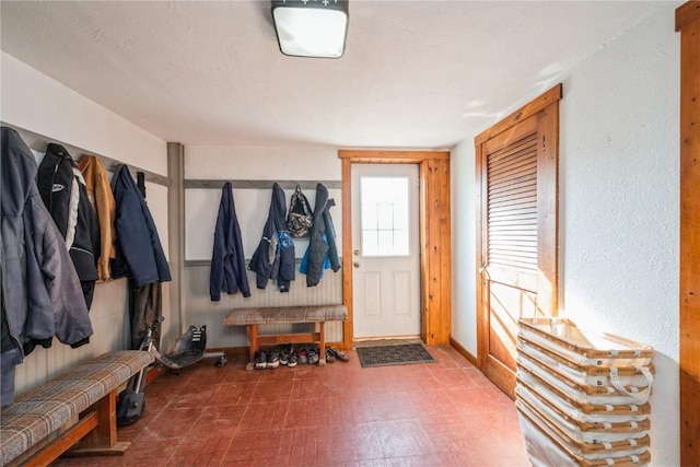 mudroom with a textured ceiling