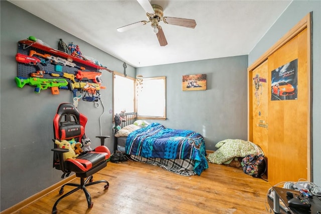 bedroom featuring hardwood / wood-style flooring and ceiling fan