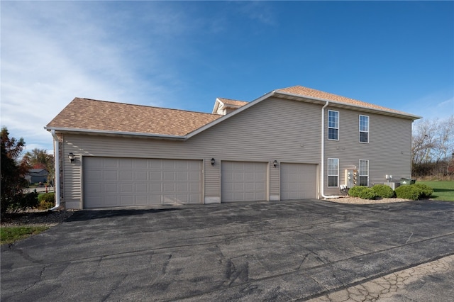 view of side of home featuring a garage