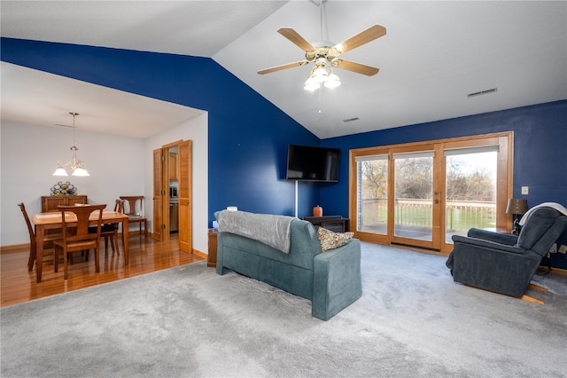 living room with carpet, lofted ceiling, and ceiling fan