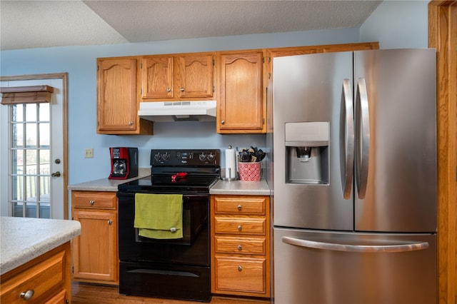 kitchen with hardwood / wood-style floors, black range with electric cooktop, stainless steel fridge with ice dispenser, and a textured ceiling