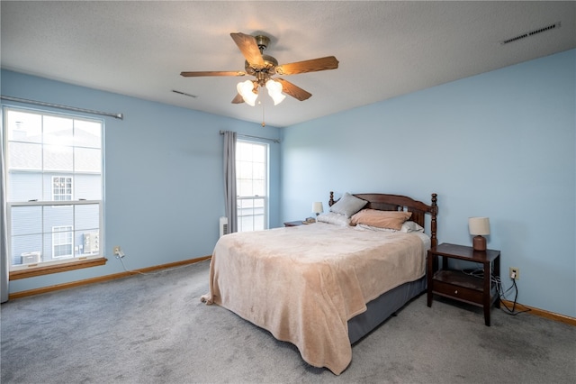 bedroom with carpet, multiple windows, and ceiling fan