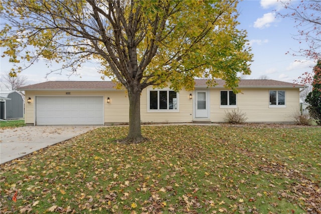 single story home with a front yard and a garage