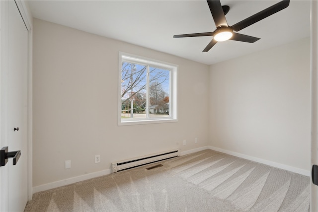 carpeted spare room with baseboard heating and ceiling fan