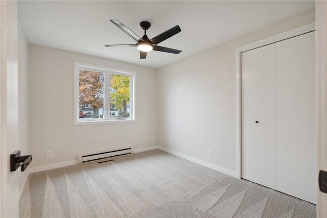 unfurnished bedroom with light carpet, ceiling fan, a baseboard radiator, and a closet