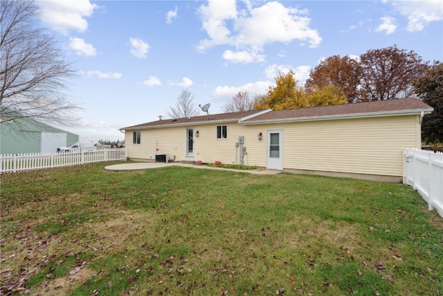 back of property with a patio area and a yard