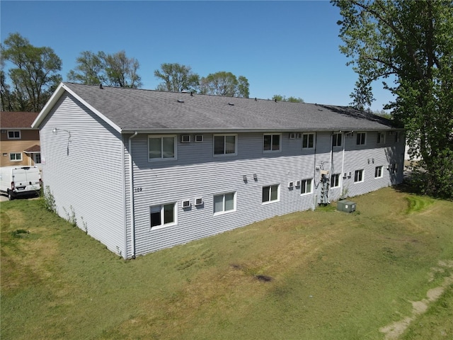 rear view of house featuring a yard