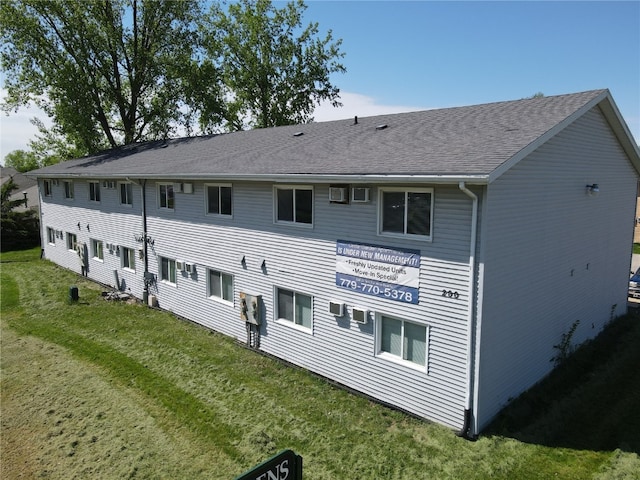 back of property featuring a yard