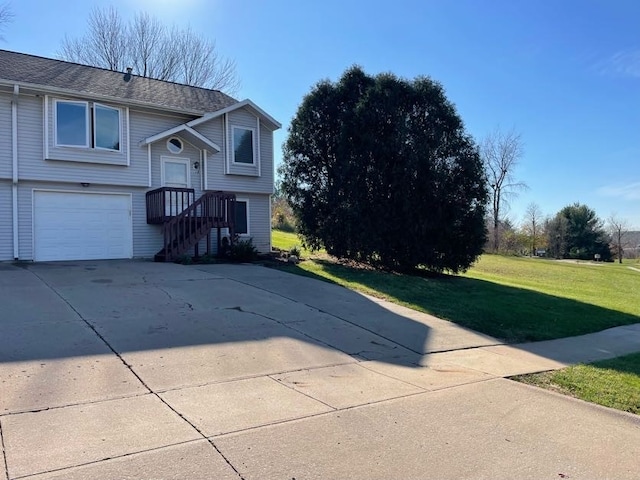 view of front of house featuring a garage and a front lawn