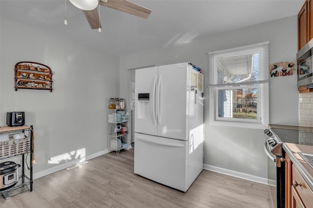 kitchen featuring light hardwood / wood-style flooring, tasteful backsplash, ceiling fan, and stainless steel appliances