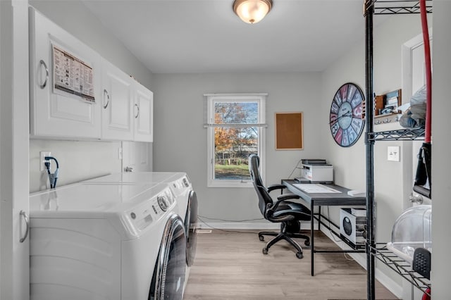 clothes washing area with cabinets, light wood-type flooring, and independent washer and dryer